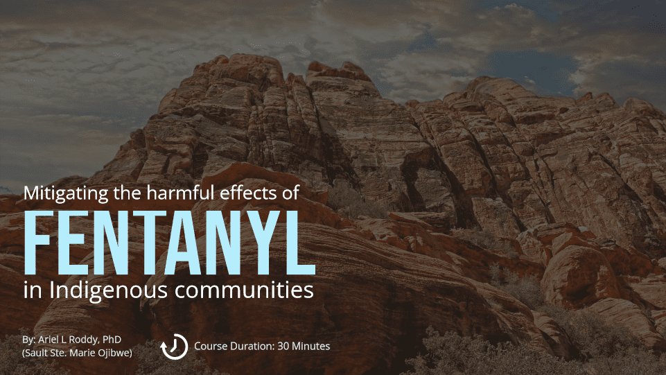 A promotional graphic for an educational course titled "Mitigating the harmful effects of FENTANYL in Indigenous communities." The course, led by Ariel L Roddy, PhD (Sault Ste. Marie Ojibwe), lasts 30 minutes. The image features a dramatic landscape of layered red rock formations under a cloudy sky, with the course title and details overlaid in white and light blue text.