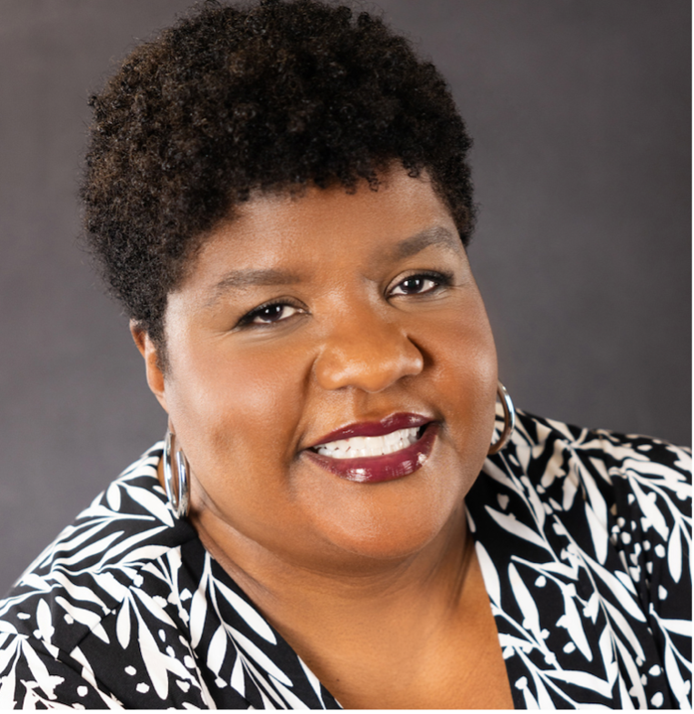 Portrait of Vanessa Bright against a grey background.